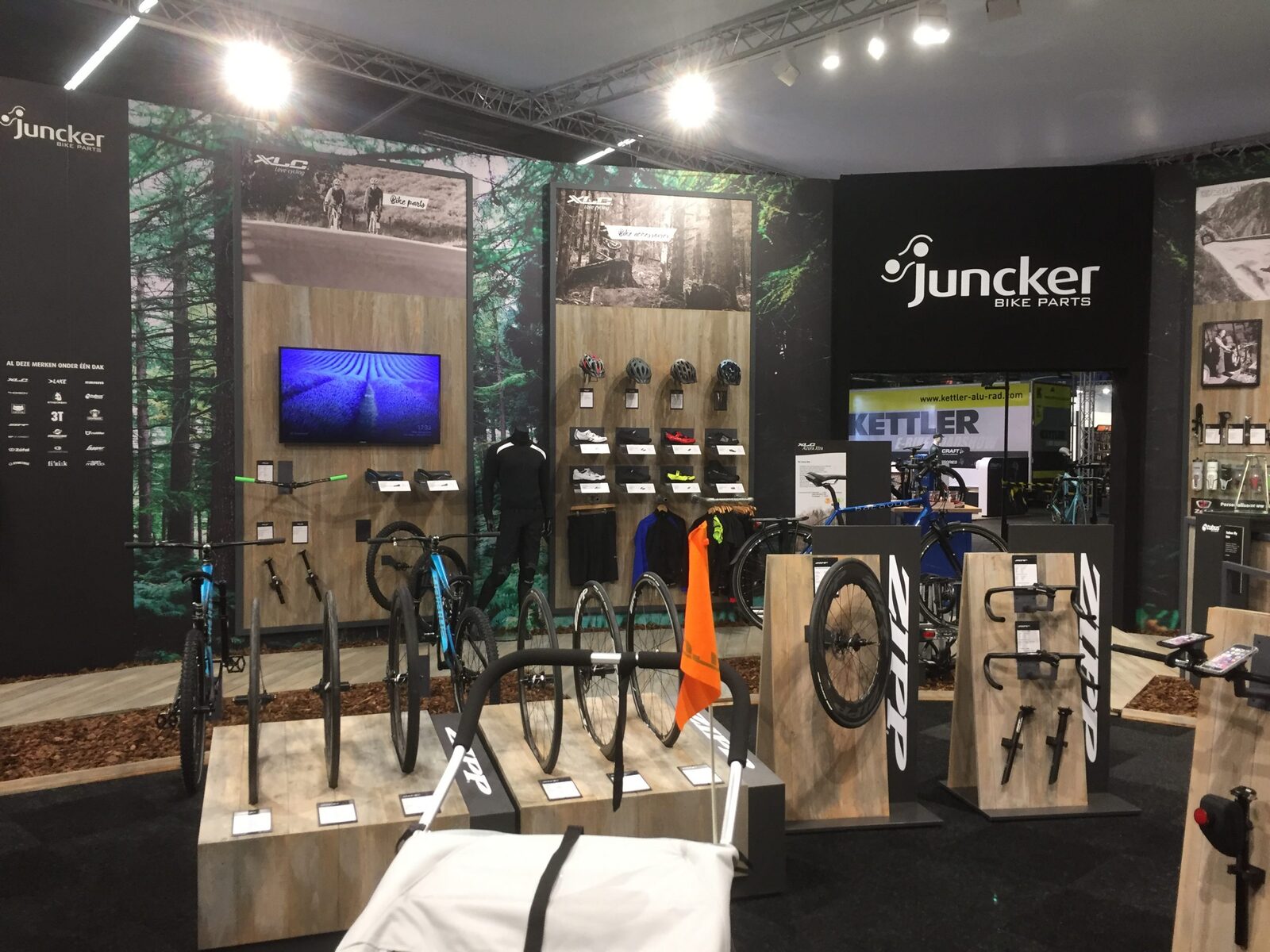 Beursstand van Juncker Bike Parts met fietsen, wielen en productwanden